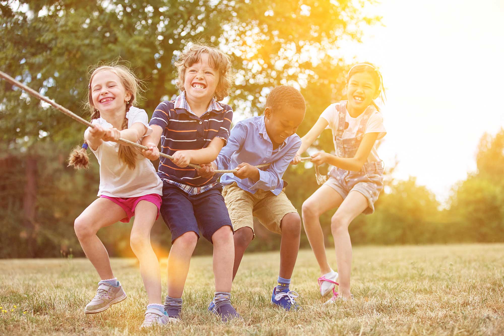 lachende Kinder beim Seilziehen